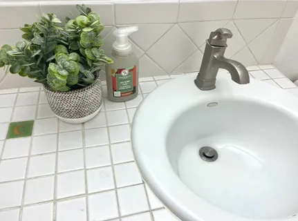 a bathroom with a double vanity sink mirror and bathtub