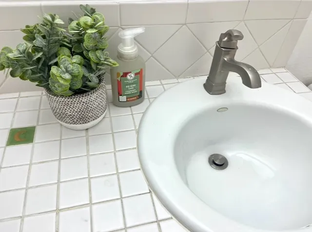 a bathroom with a double vanity sink mirror and bathtub