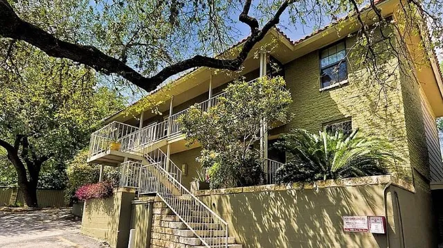 a view of a house with a tree