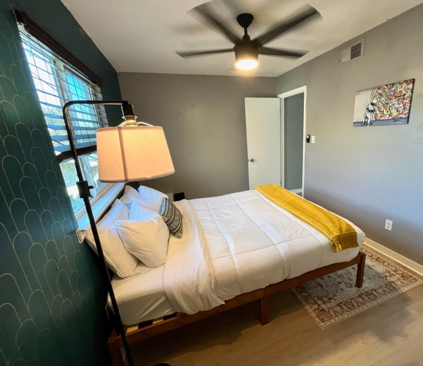 2302 East Side Drive, Unit 30 Austin, TX 78704 - Photo 5 of 22 a bed sitting in a bedroom next to a window