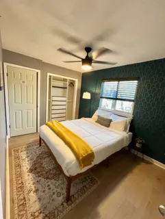 a bed sitting in a bedroom next to a window