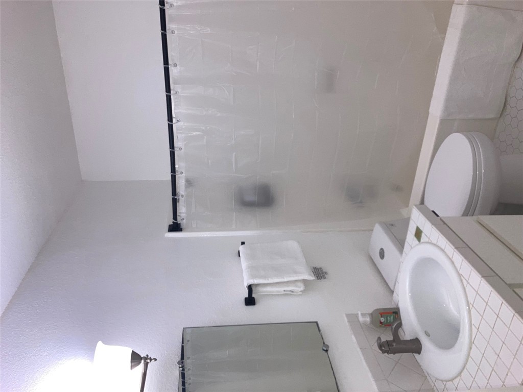 2302 East Side Drive, Unit 30 Austin, TX 78704 - Photo 9 of 22 a bathroom with a sink toilet and vanity