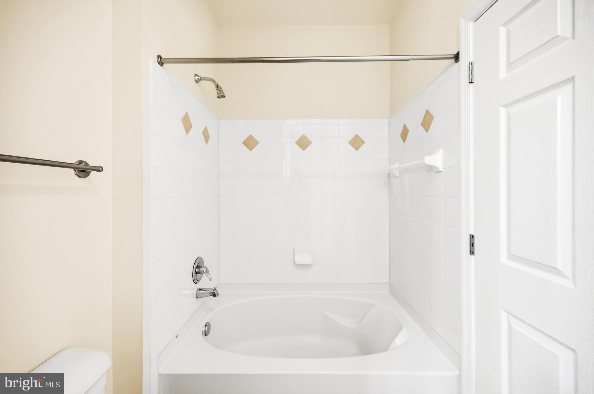 16 Granite Place, Unit 280 Gaithersburg, MD 20878 - Photo 32 of 47 a white bath tub with a shower curtain