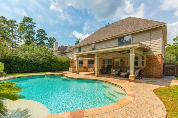 a view of a house with swimming pool and sitting area