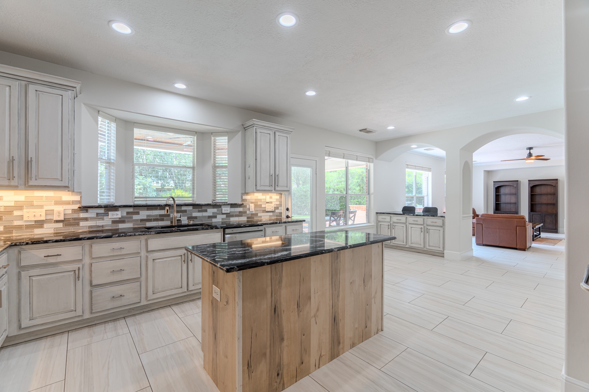 7 Stickley Court The Woodlands, TX 77382 - Photo 12 of 33 a kitchen with counter top space sink and living room