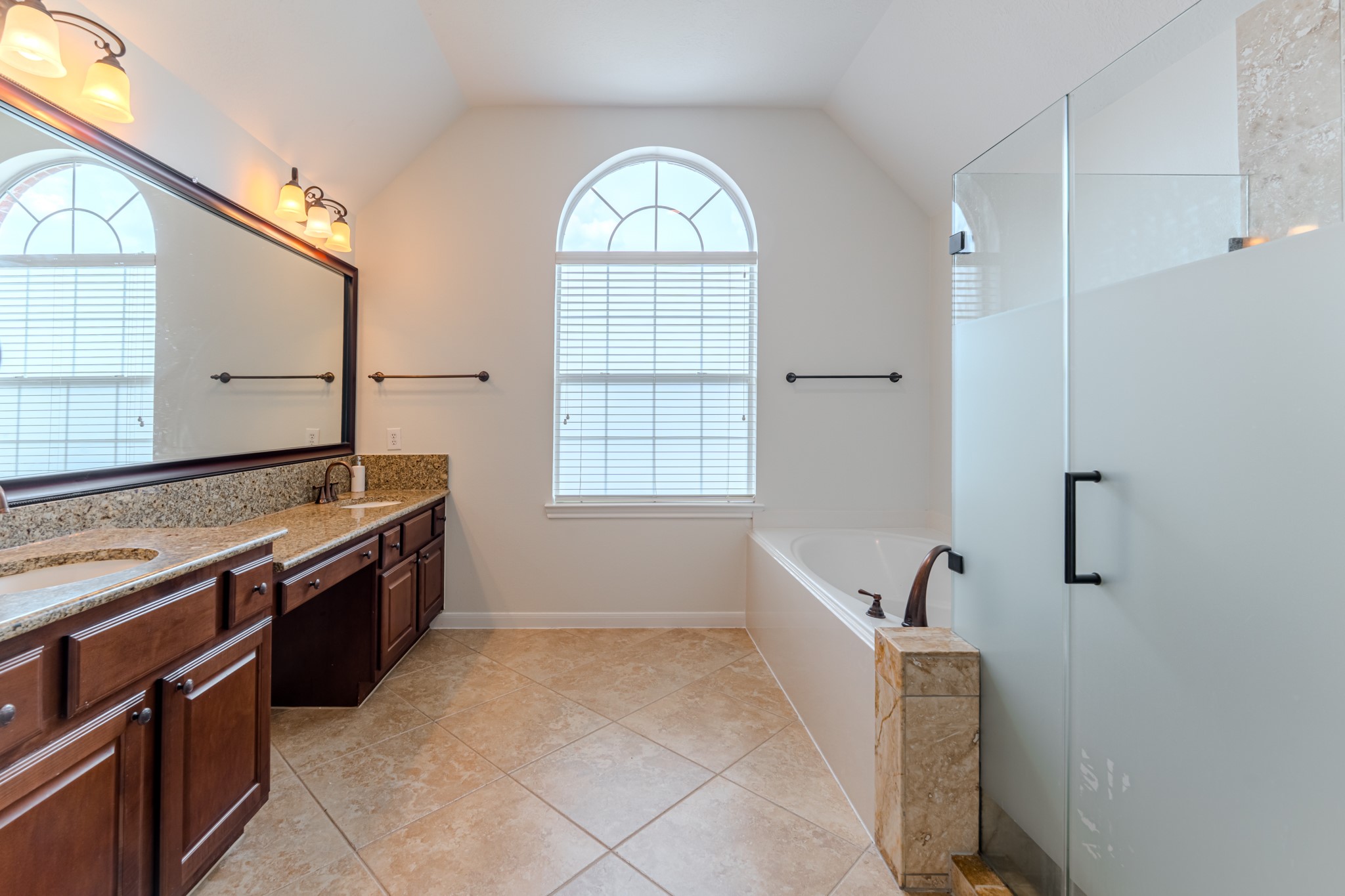 7 Stickley Court The Woodlands, TX 77382 - Photo 27 of 33 a large bathroom with a granite countertop sink and a mirror
