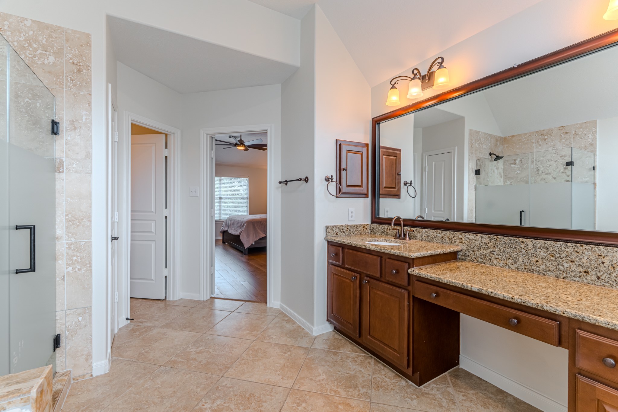 7 Stickley Court The Woodlands, TX 77382 - Photo 28 of 33 a spacious bathroom with a sink and a mirror