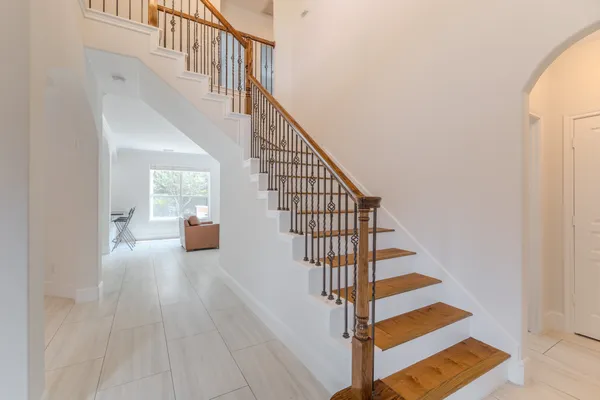 a view of entryway and hall with wooden floor