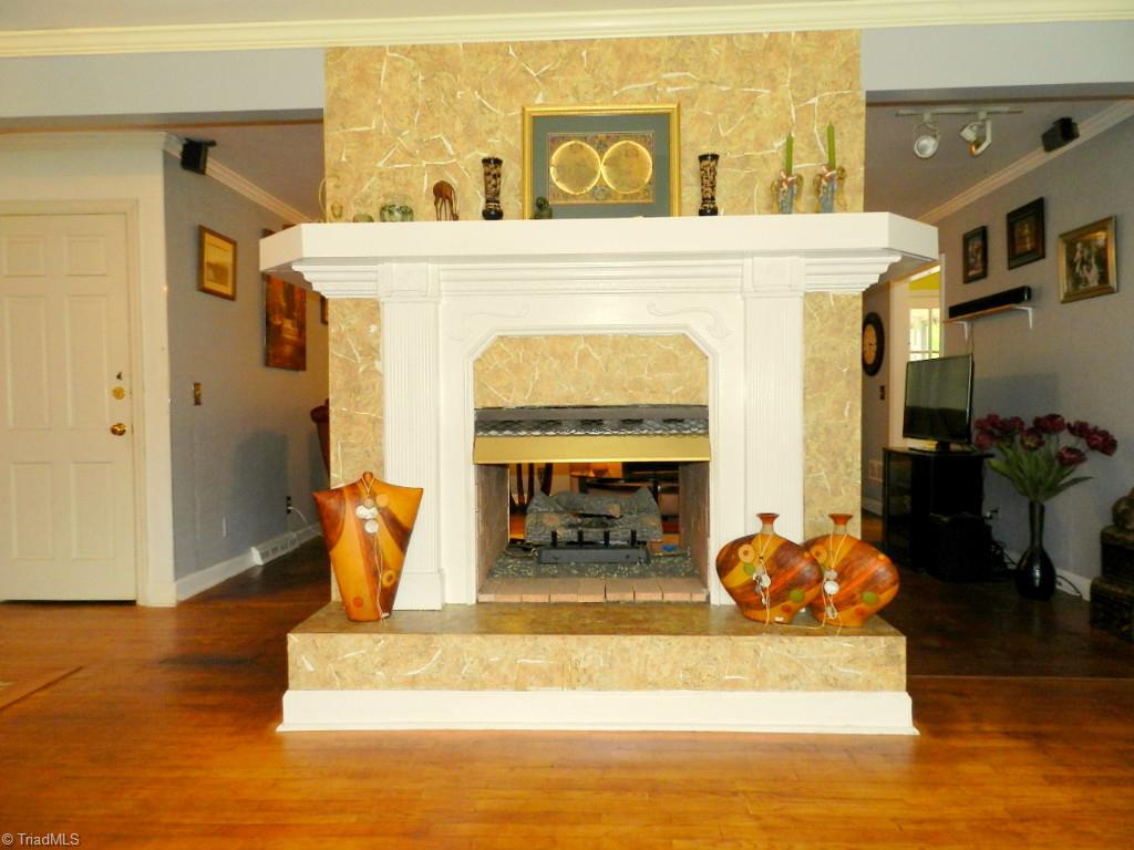 5406 Mockingbird Road Greensboro, NC 27406 - Photo 6 of 30 Focal point of living room and den is the see through fireplace!