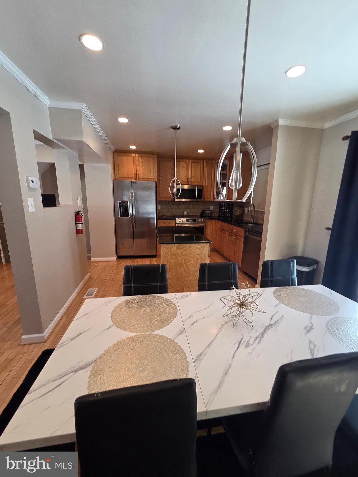 2122 Princess Anne Court Bowie, MD 20716 - Photo 13 of 37 a kitchen with a sink a stove and chairs