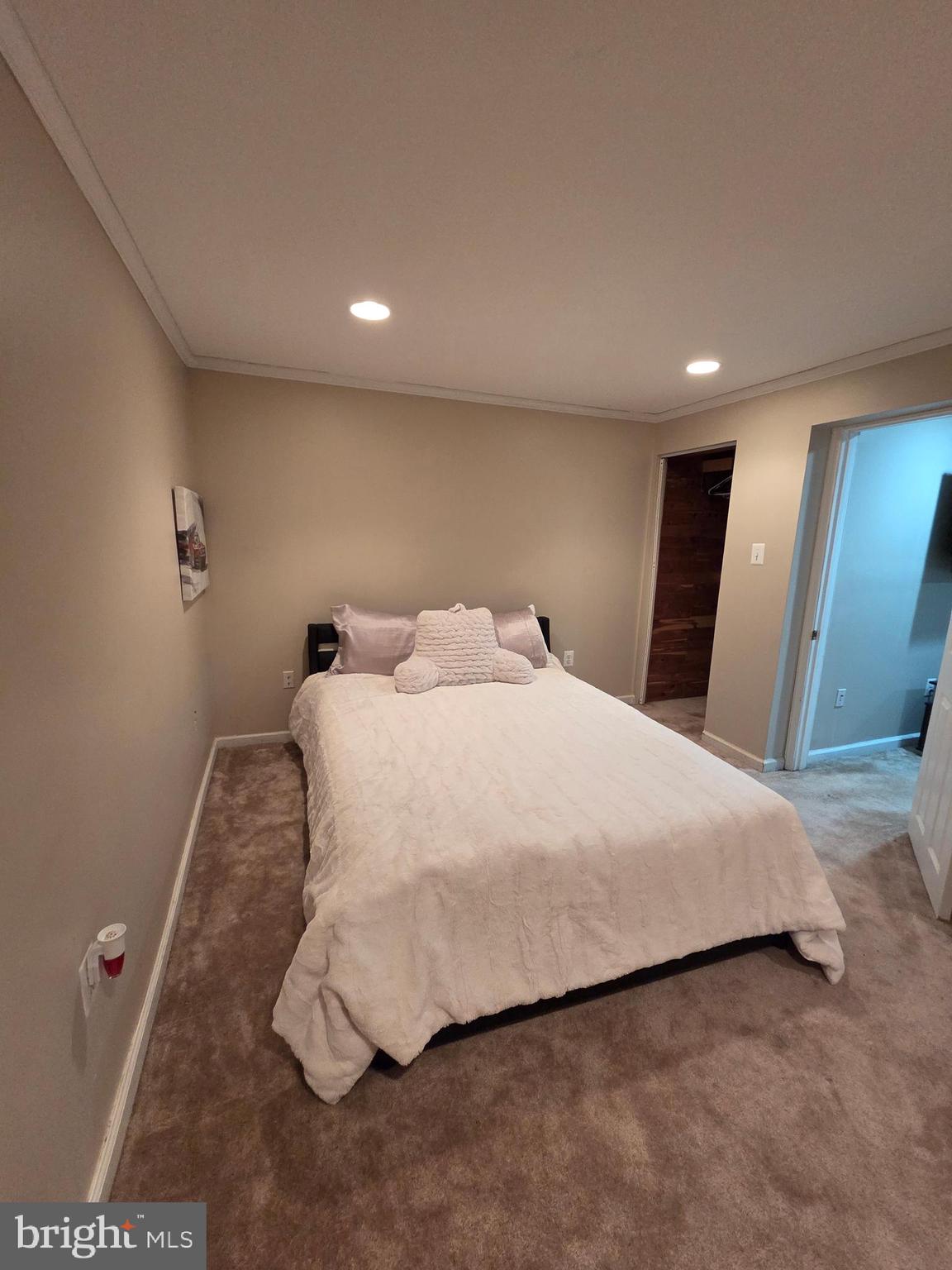 2122 Princess Anne Court Bowie, MD 20716 - Photo 34 of 37 a bedroom with a bed and a mirror