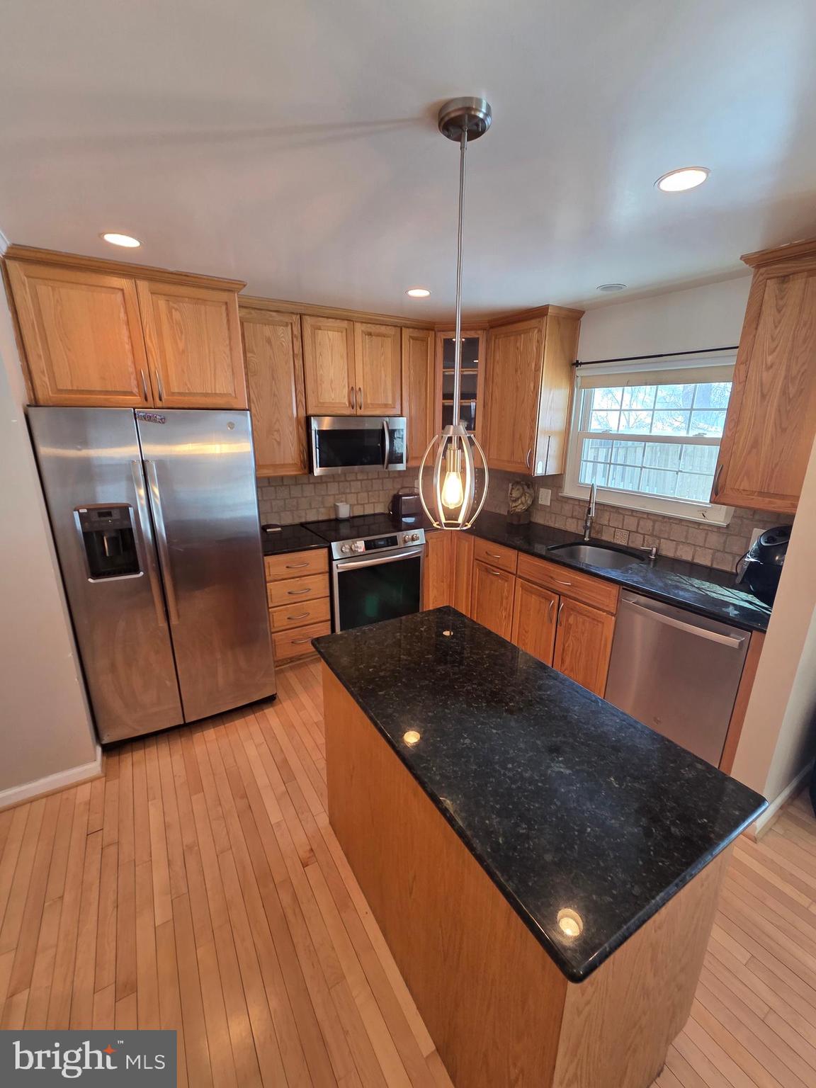 2122 Princess Anne Court Bowie, MD 20716 - Photo 8 of 37 a kitchen with stainless steel appliances granite countertop a refrigerator a stove a sink and a wooden floors