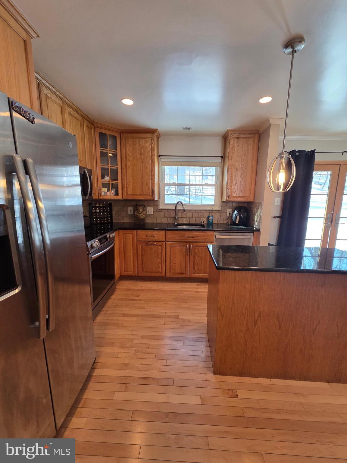 2122 Princess Anne Court Bowie, MD 20716 - Photo 10 of 37 a large kitchen with stainless steel appliances kitchen island granite countertop a refrigerator a stove a sink and a microwave