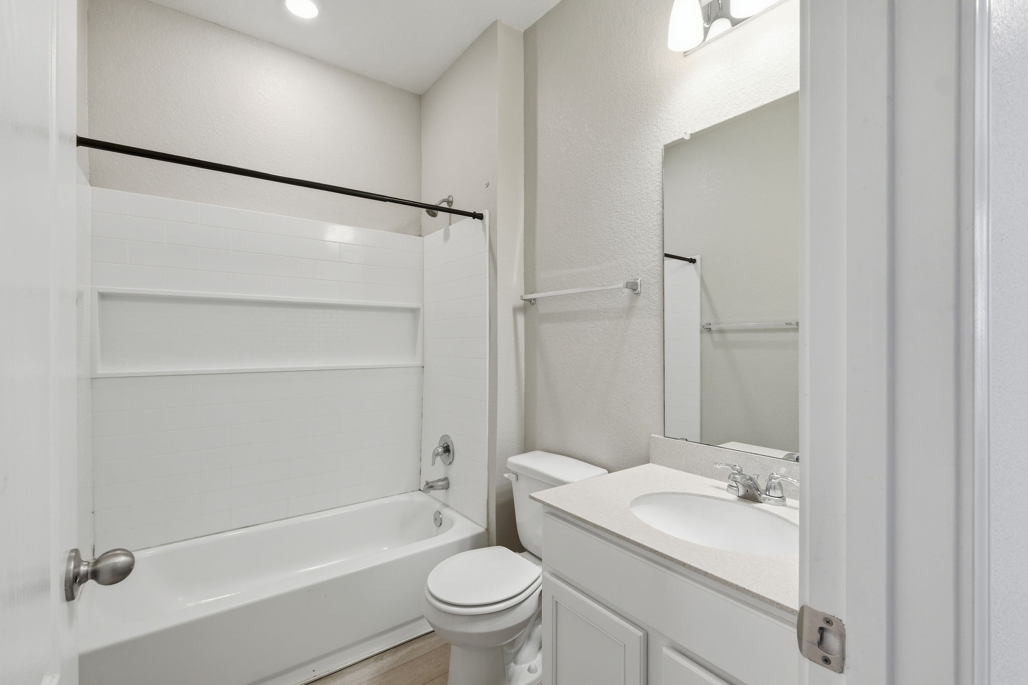 513 Thunder Valley Trail Georgetown, TX 78626 - Photo 11 of 15 Full bathroom featuring washtub / shower combination, vanity, a textured wall, recessed lighting, and light wood-type flooring