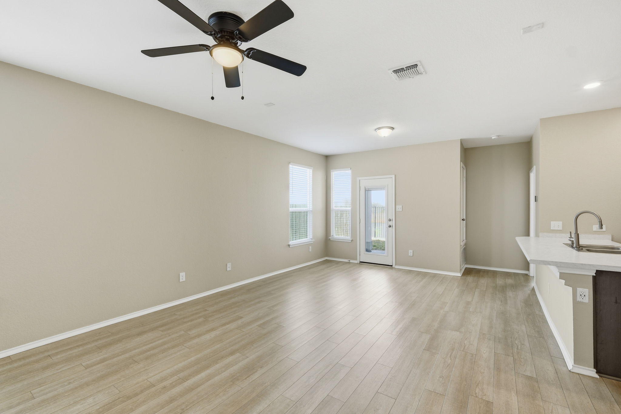 513 Thunder Valley Trail Georgetown, TX 78626 - Photo 3 of 15 Unfurnished living room featuring a ceiling fan and light wood-style floors