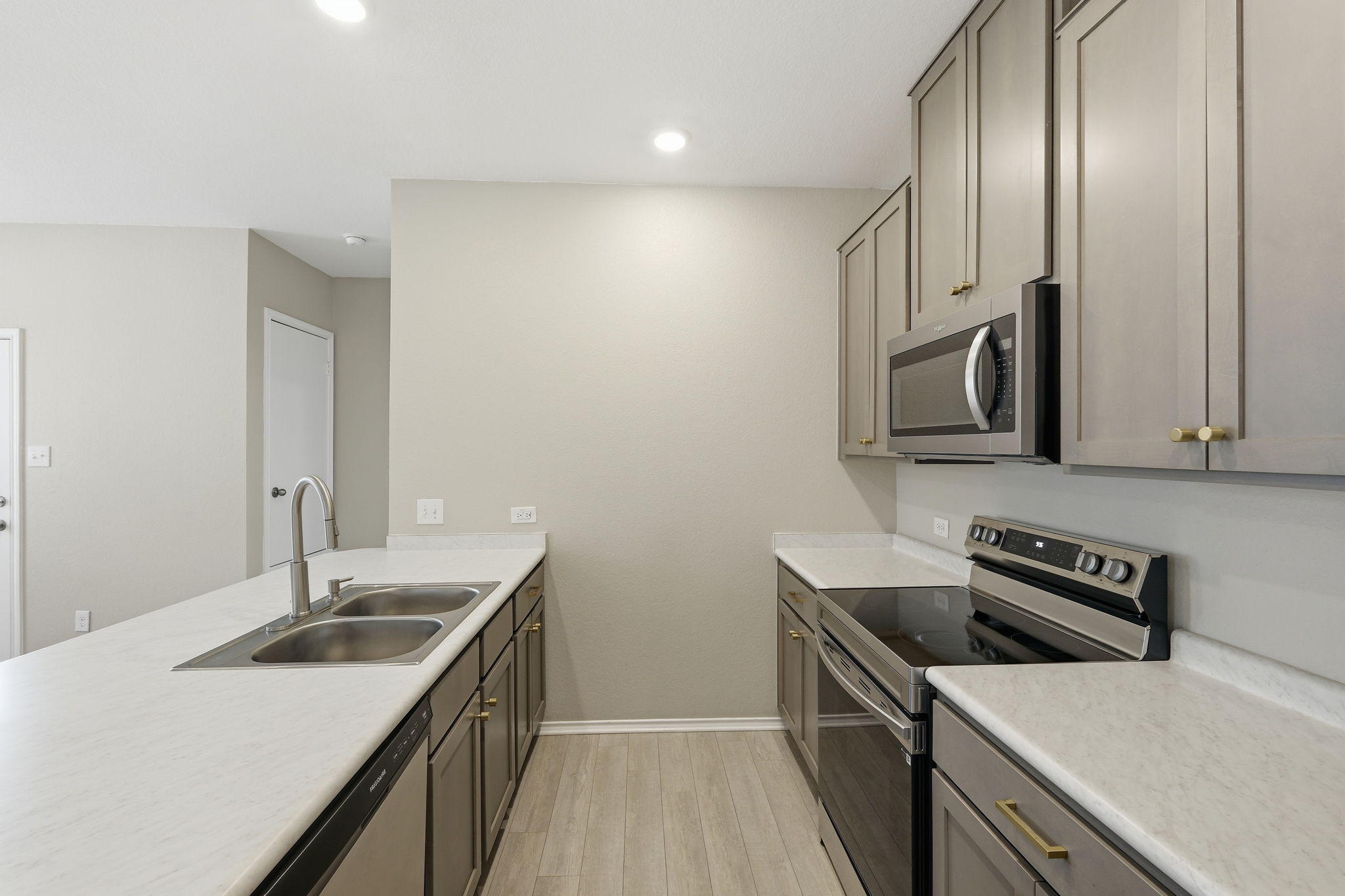 513 Thunder Valley Trail Georgetown, TX 78626 - Photo 6 of 15 Kitchen with stainless steel appliances, gray cabinets, light countertops, a peninsula, and recessed lighting