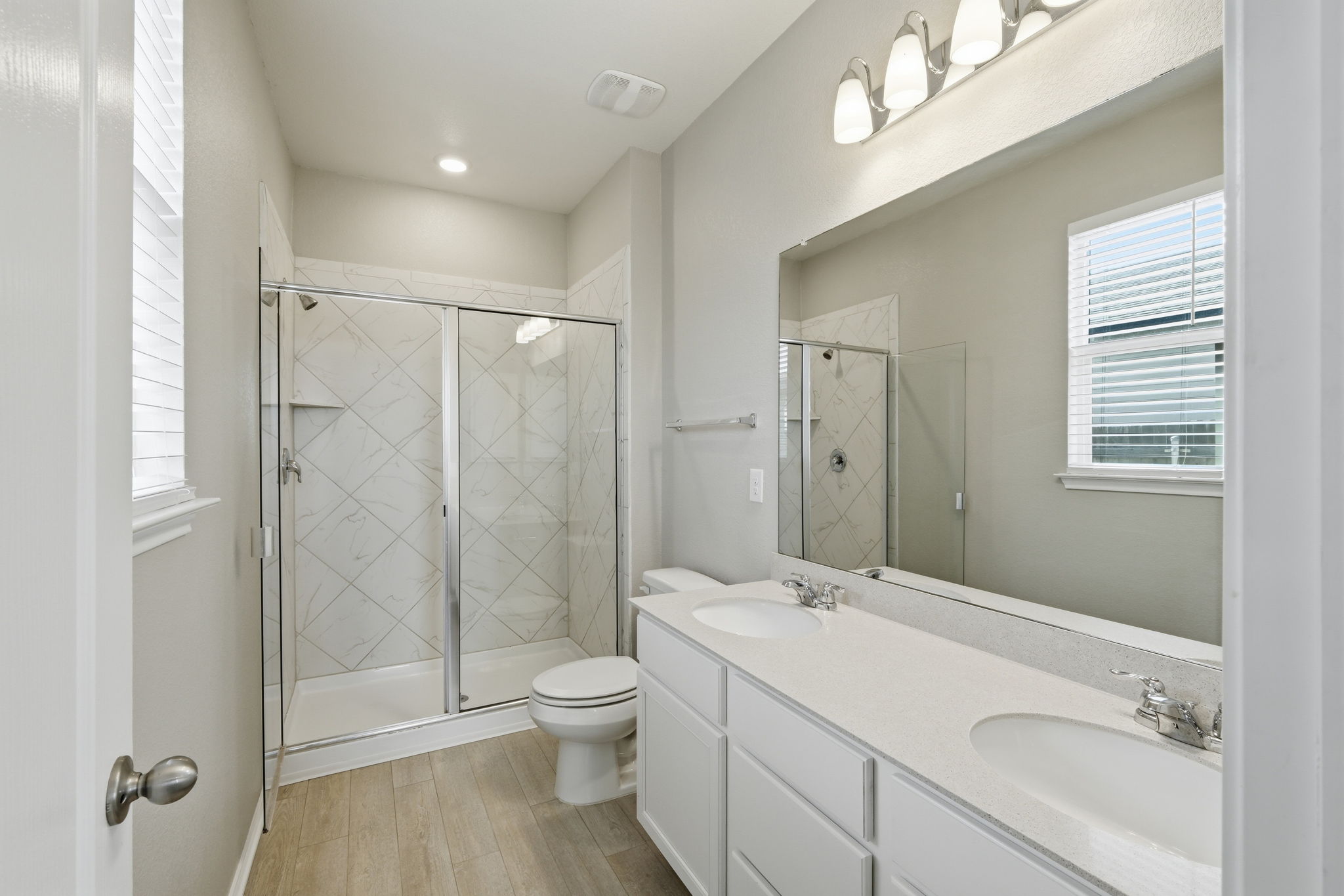 513 Thunder Valley Trail Georgetown, TX 78626 - Photo 9 of 15 Full bathroom with a shower stall, healthy amount of natural light, and double vanity