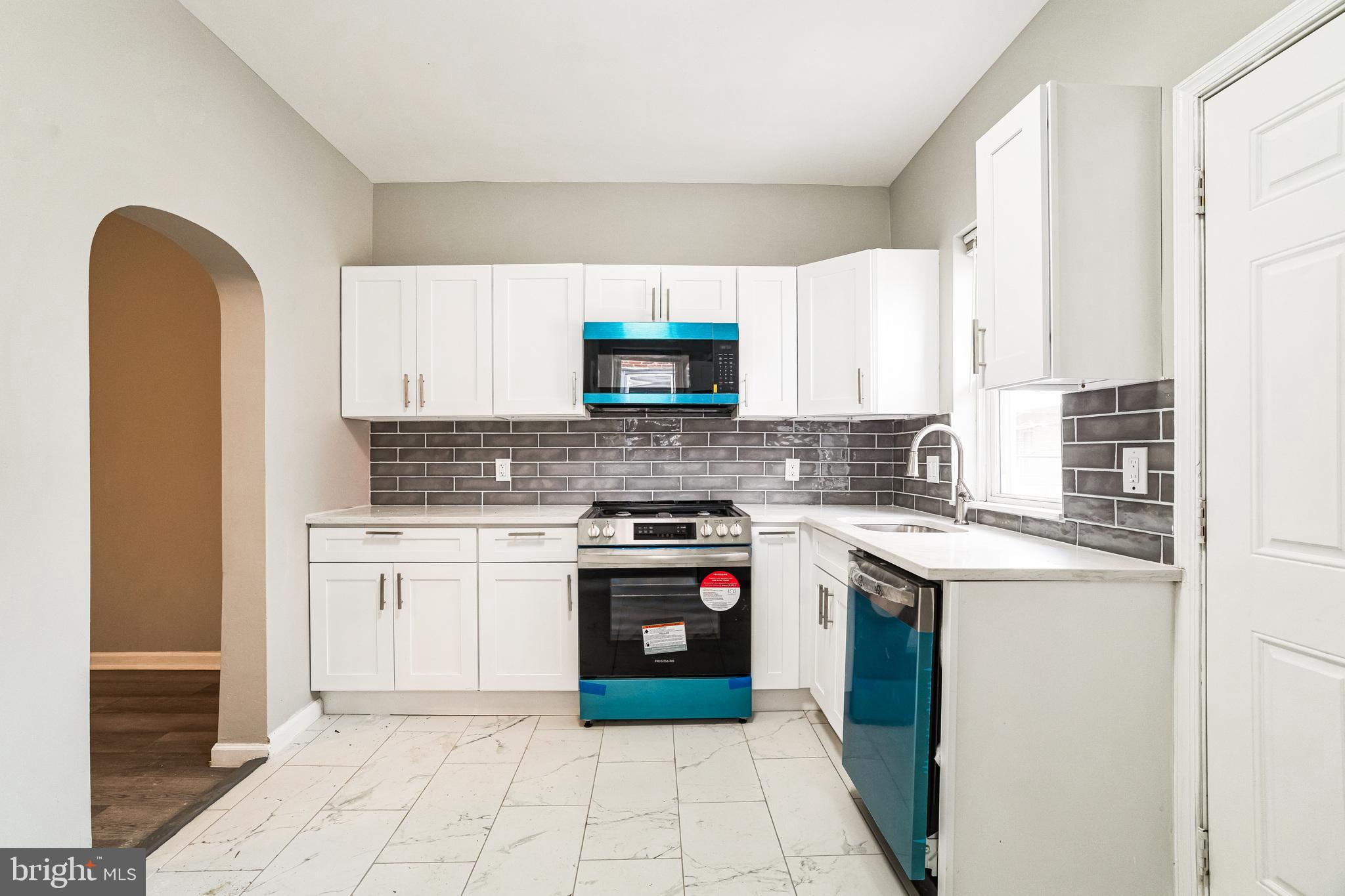 5745 Addison Street Philadelphia, PA 19143 - Photo 11 of 24 a kitchen with a stove top oven sink and cabinets