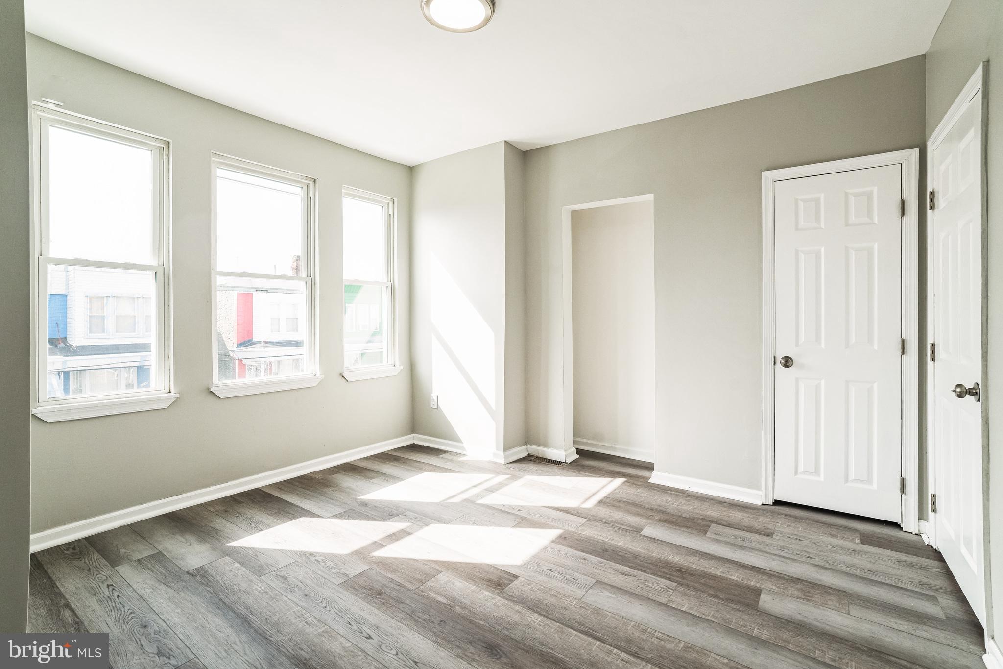 5745 Addison Street Philadelphia, PA 19143 - Photo 15 of 24 a view of an empty room with wooden floor and a window
