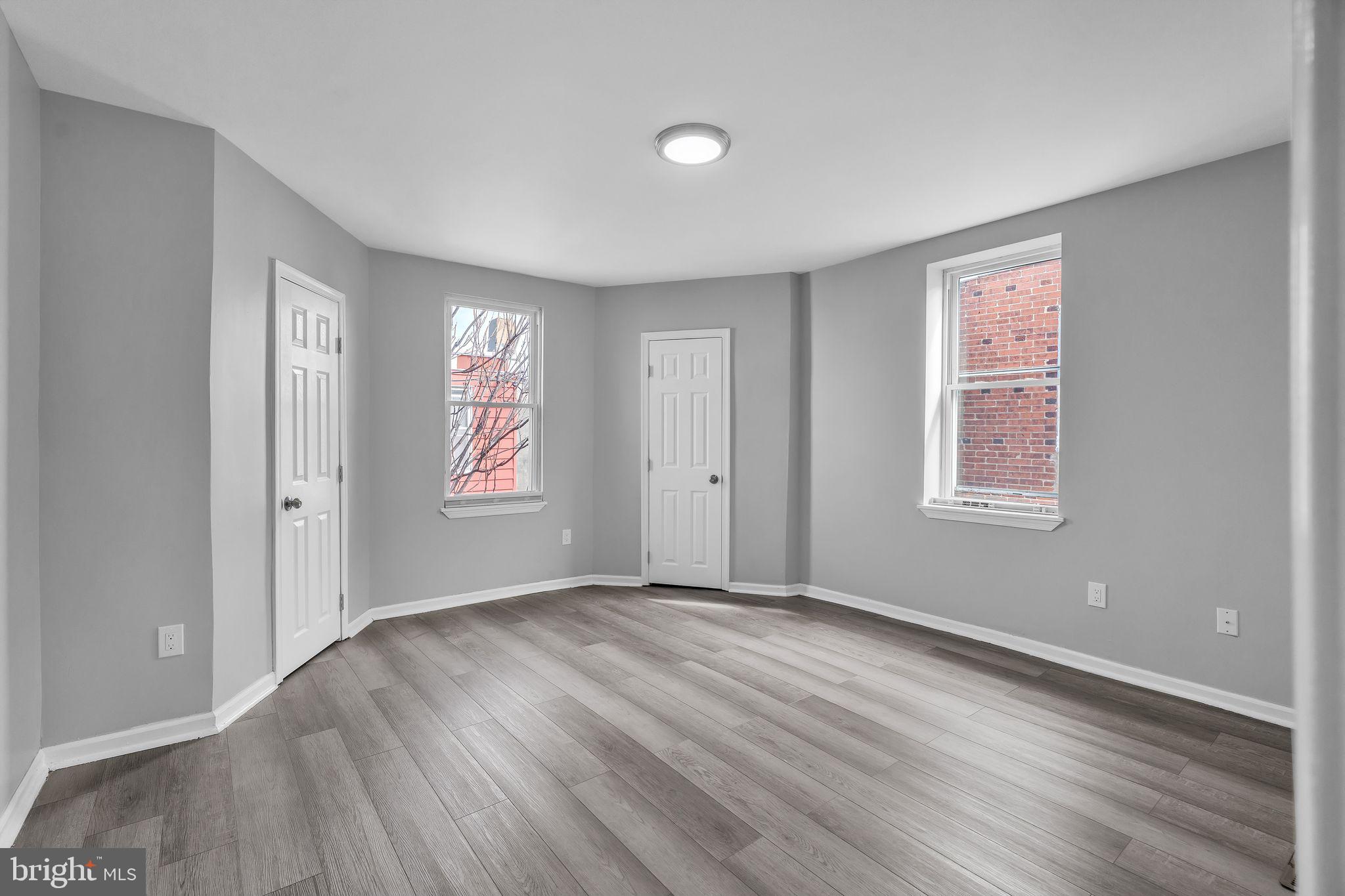 5745 Addison Street Philadelphia, PA 19143 - Photo 18 of 24 a view of an empty room with wooden floor and a window