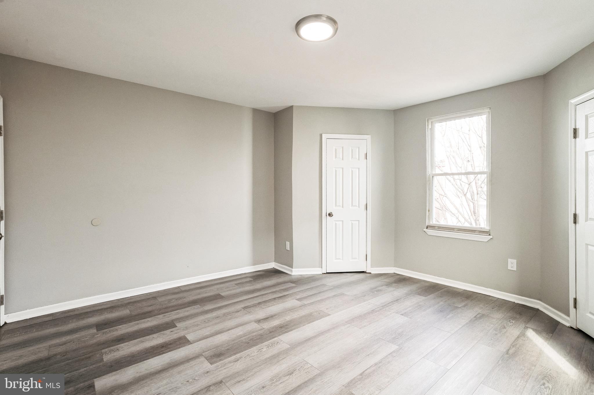 5745 Addison Street Philadelphia, PA 19143 - Photo 19 of 24 an empty room with wooden floor and windows