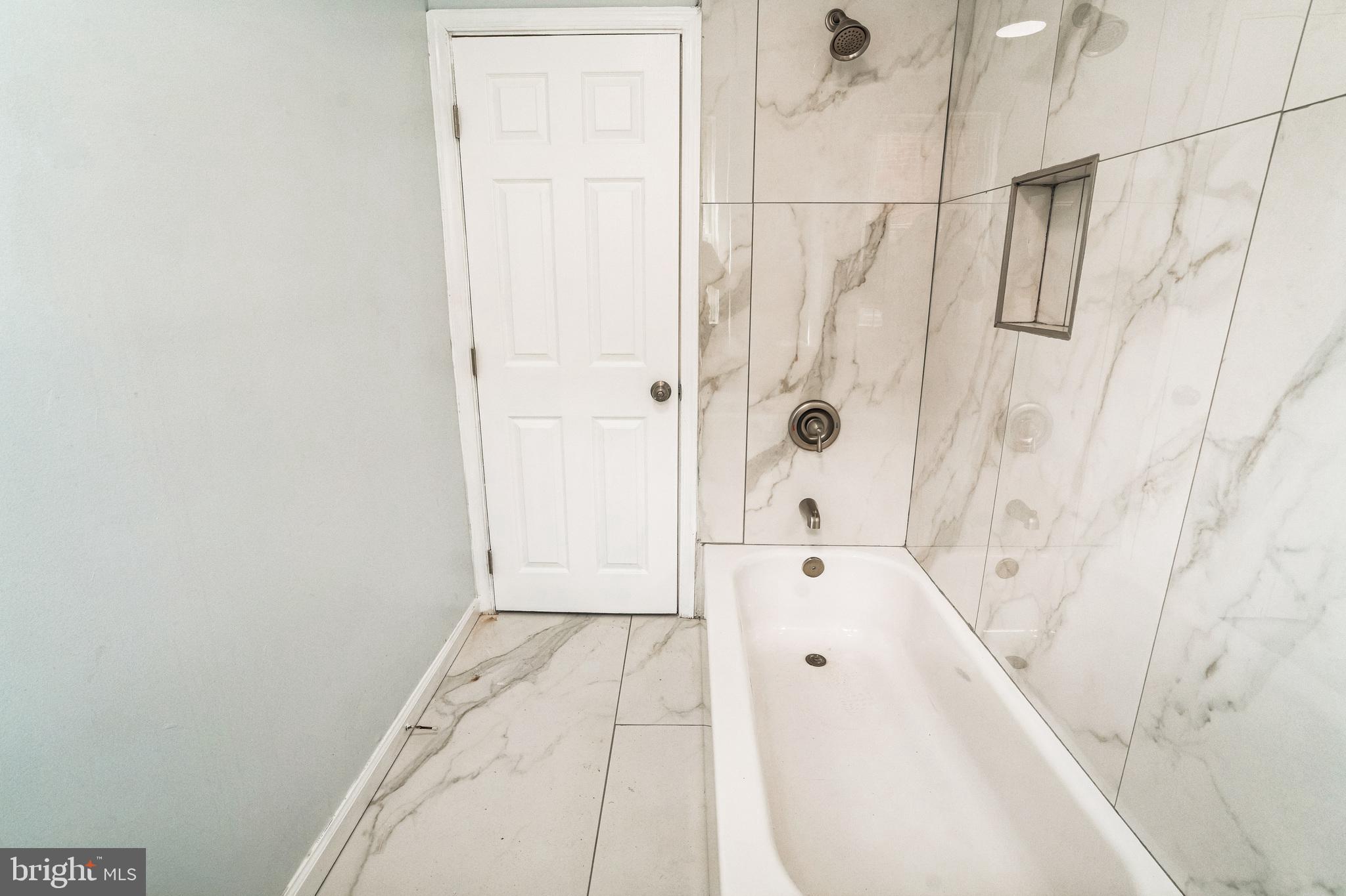 5745 Addison Street Philadelphia, PA 19143 - Photo 21 of 24 a bathroom with a bathtub and shower