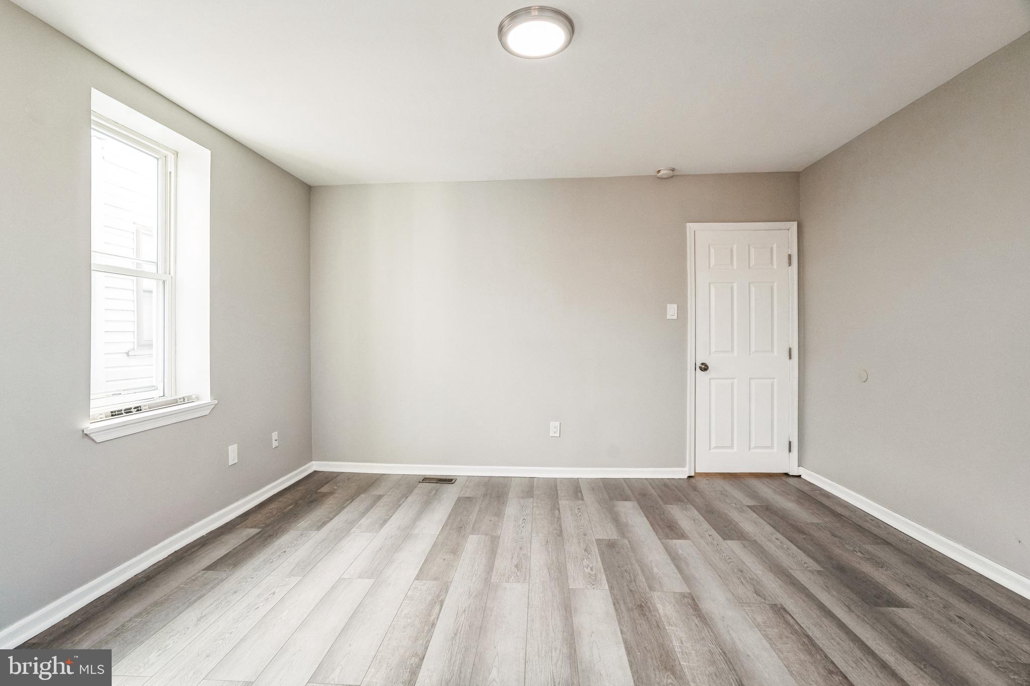 5745 Addison Street Philadelphia, PA 19143 - Photo 22 of 24 a view of room with window and hardwood floor