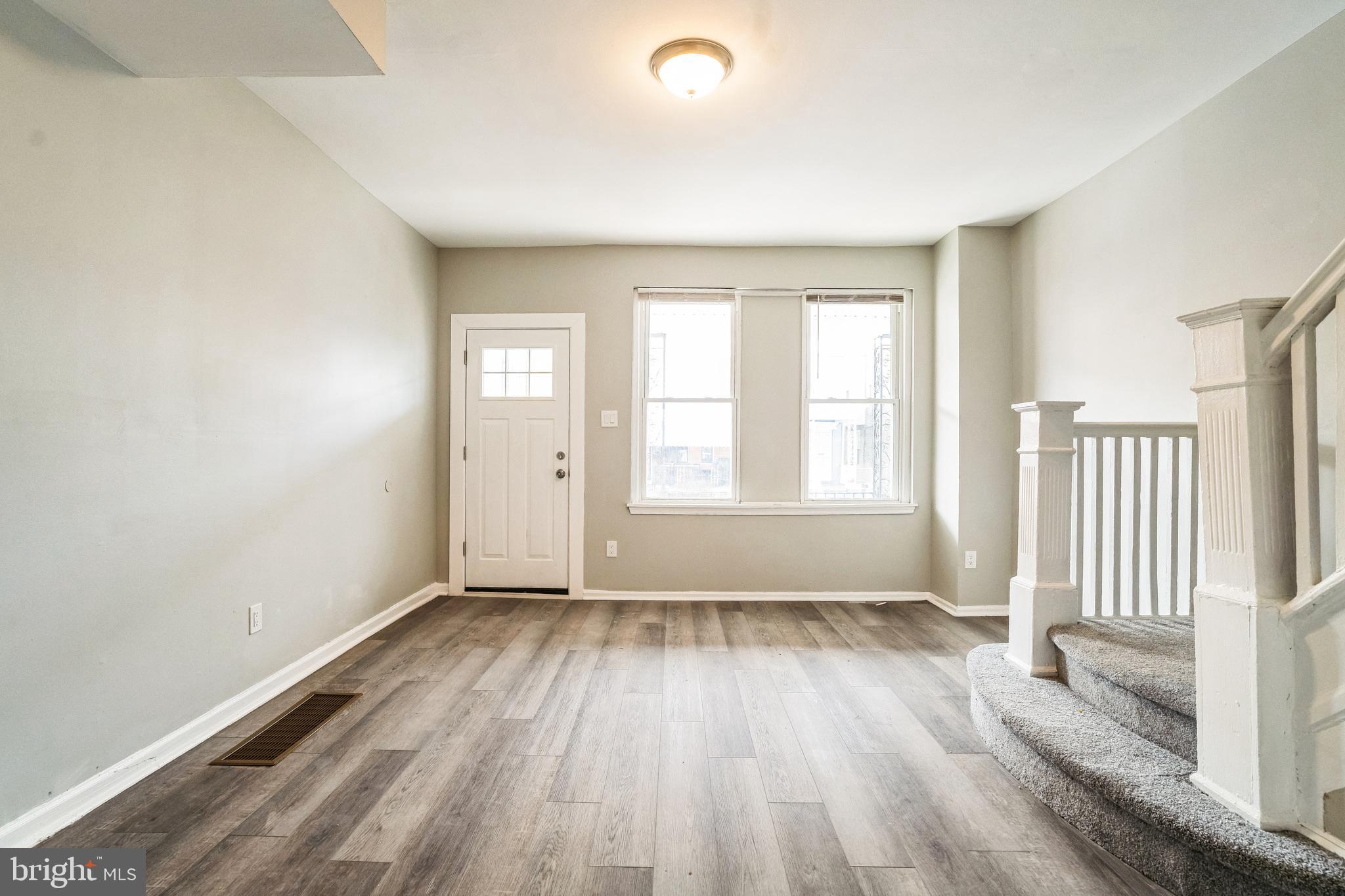 5745 Addison Street Philadelphia, PA 19143 - Photo 3 of 24 a view of an empty room with wooden floor and a window