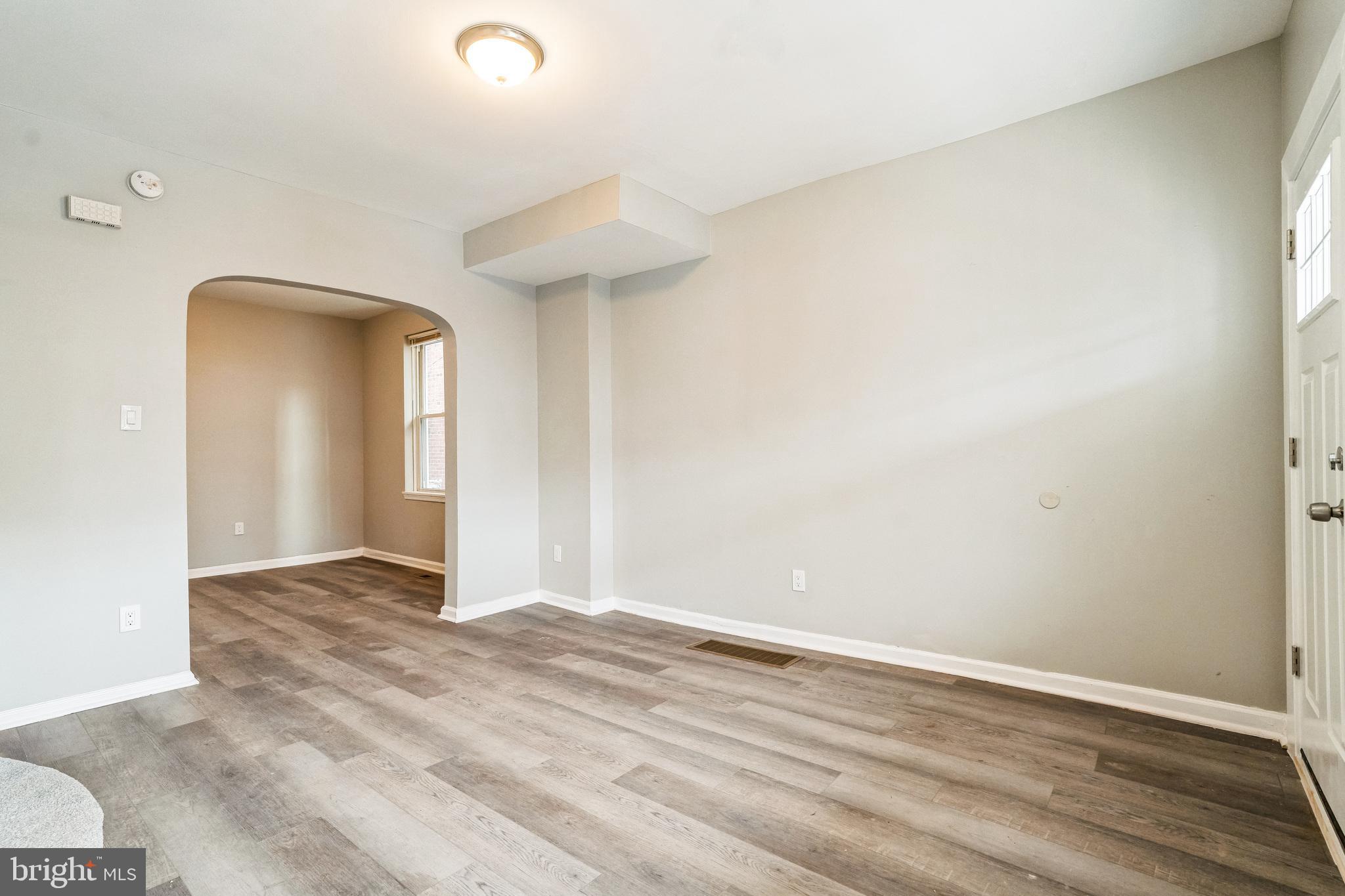 5745 Addison Street Philadelphia, PA 19143 - Photo 6 of 24 an empty room with wooden floor and windows