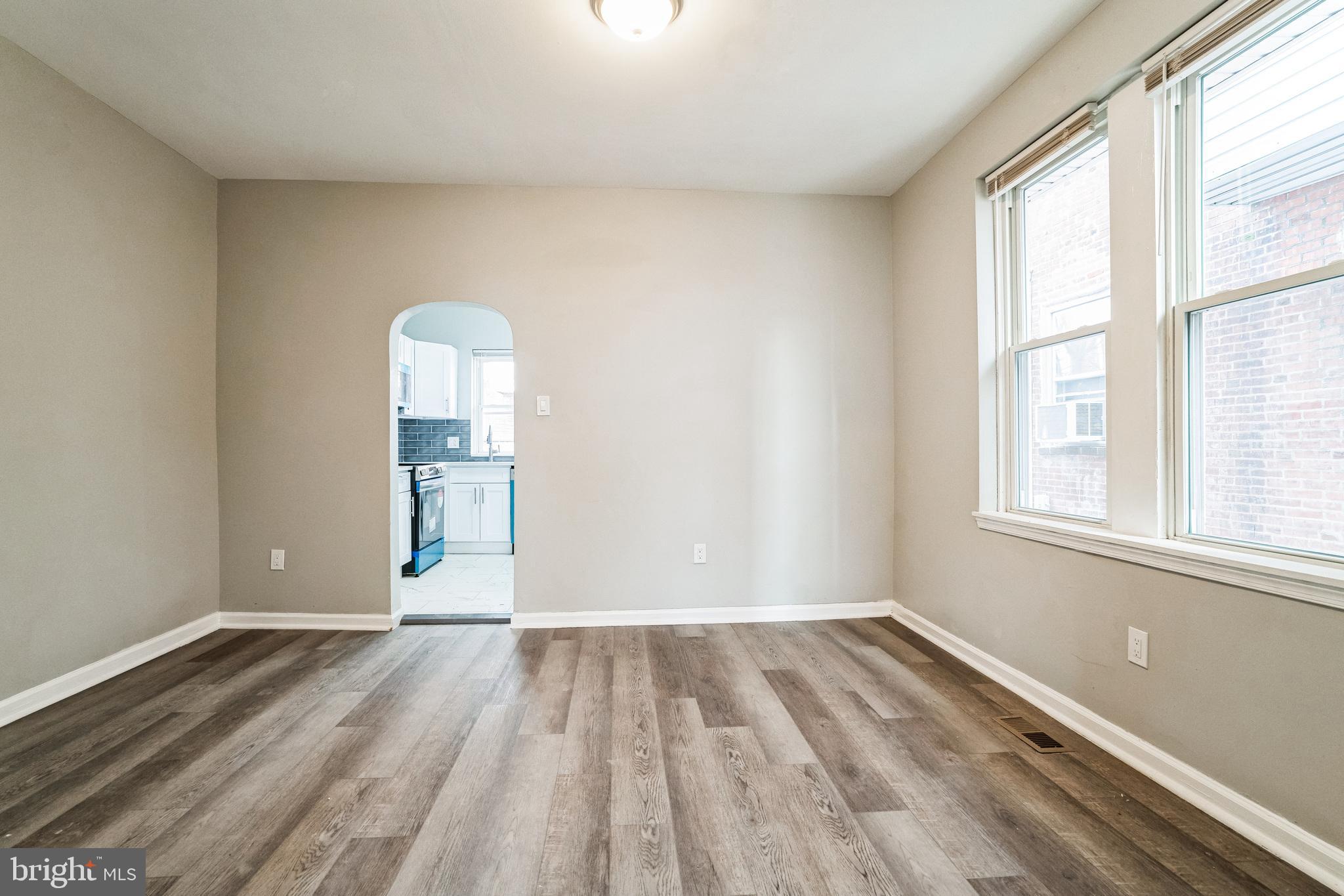 5745 Addison Street Philadelphia, PA 19143 - Photo 7 of 24 an empty room with wooden floor and windows