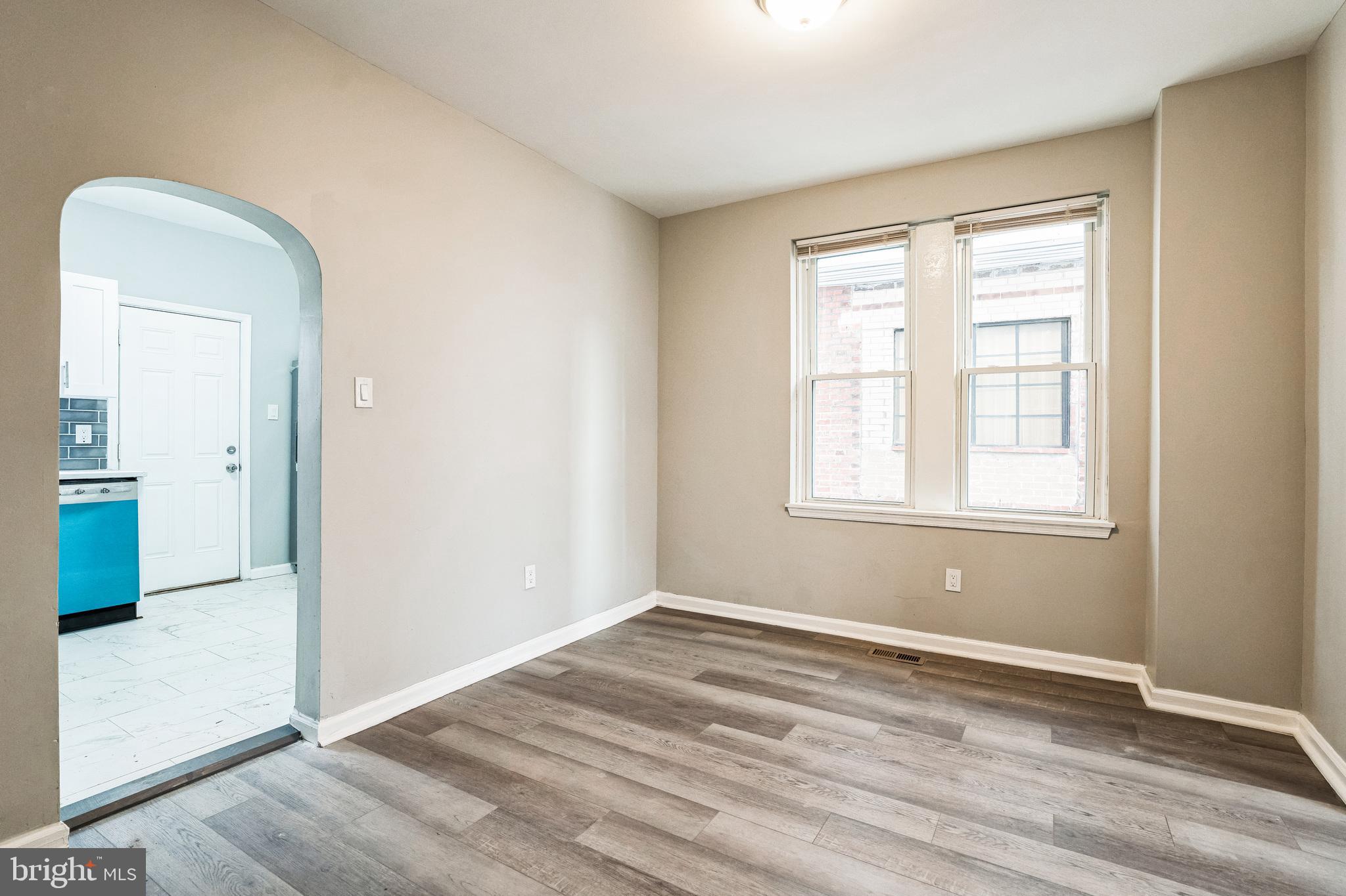 5745 Addison Street Philadelphia, PA 19143 - Photo 8 of 24 an empty room with wooden floor and windows