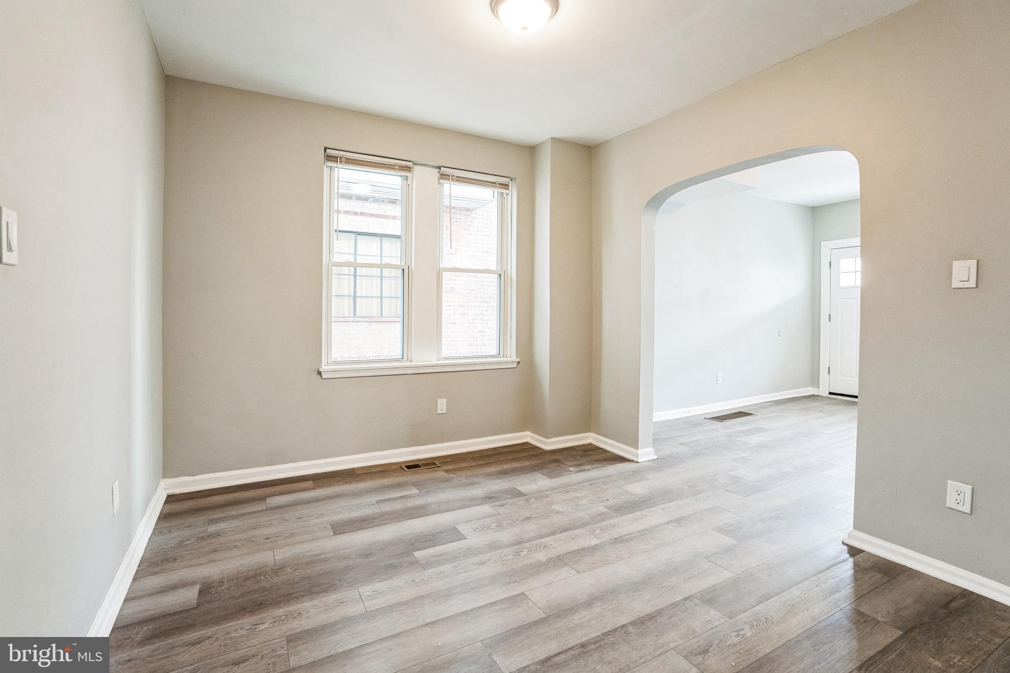 5745 Addison Street Philadelphia, PA 19143 - Photo 9 of 24 an empty room with wooden floor and windows