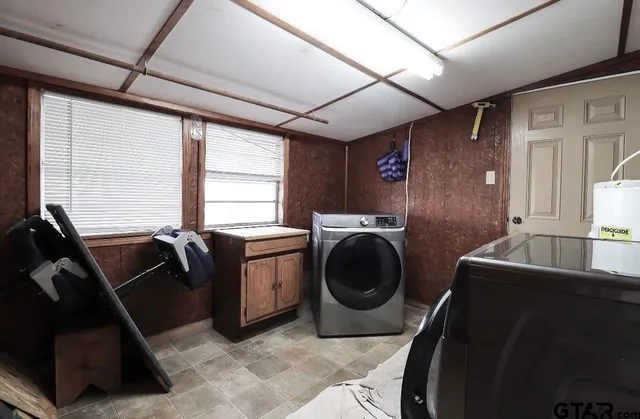 a living room with furniture a washer and dryer