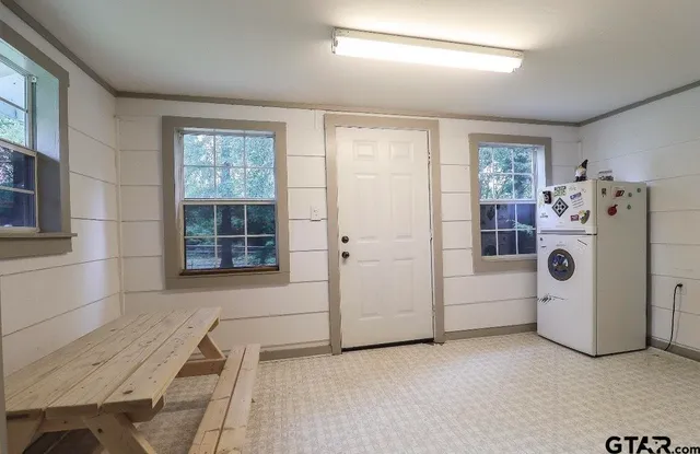 a view of a livingroom with furniture and white walls