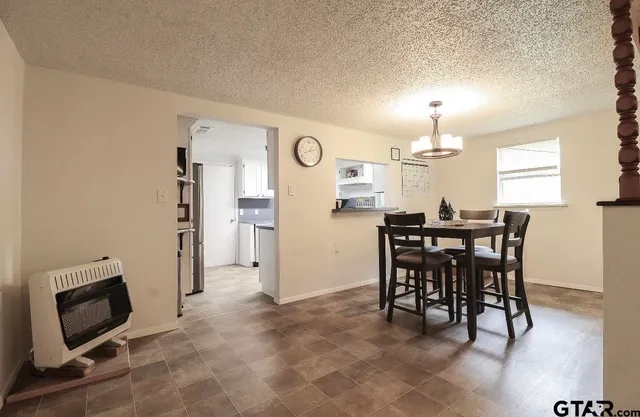 a view of a dining room with furniture and a chandelier