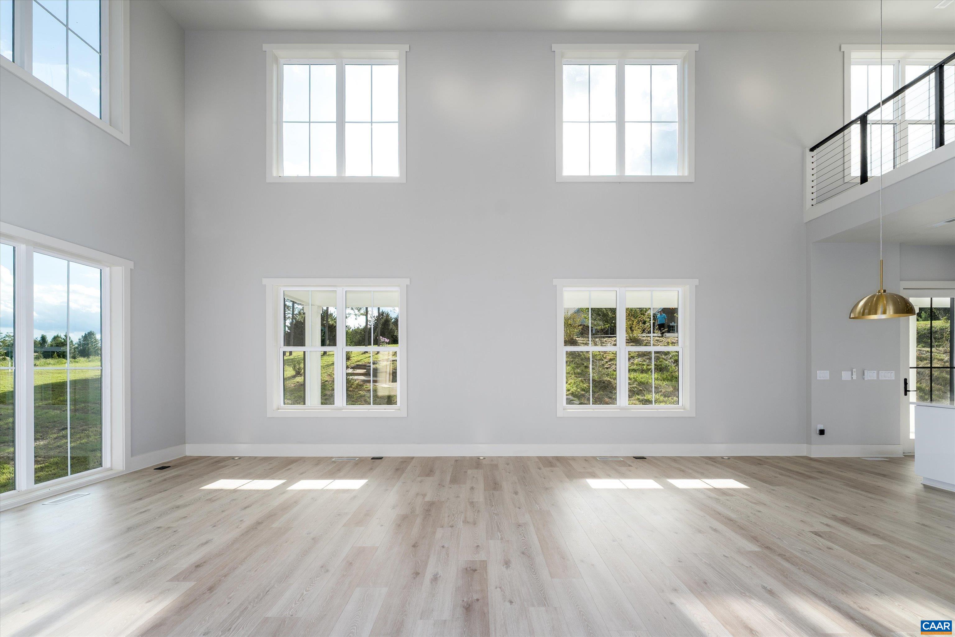 199 Ridgeview Drive Ruckersville, VA 22968 - Photo 33 of 72 an empty room with wooden floor and windows
