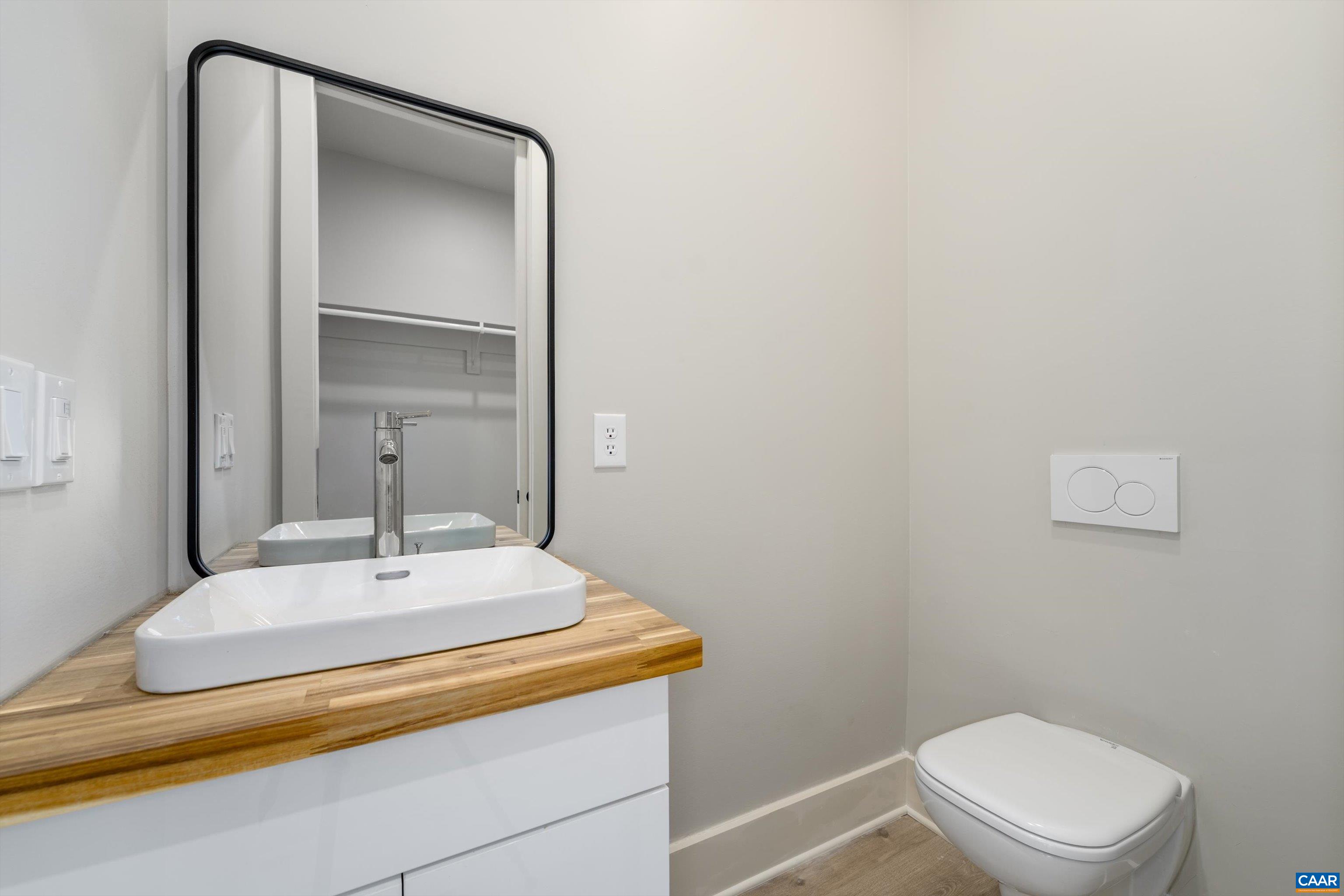 199 Ridgeview Drive Ruckersville, VA 22968 - Photo 36 of 72 a bathroom with a sink a toilet and mirror