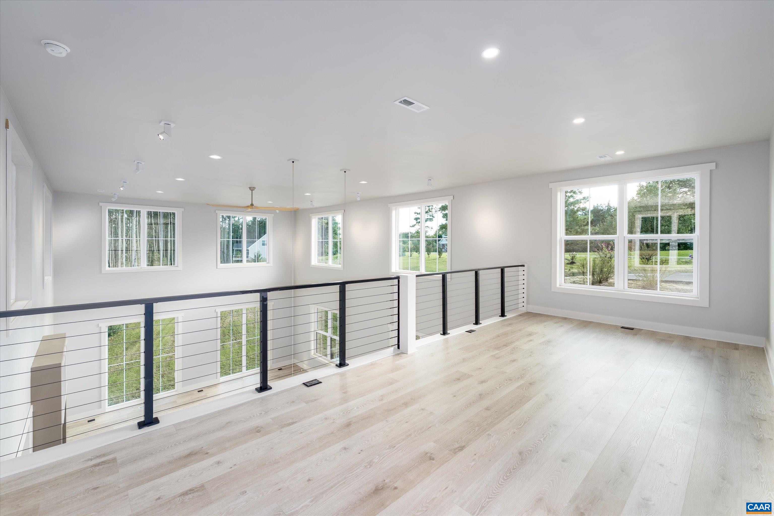 199 Ridgeview Drive Ruckersville, VA 22968 - Photo 52 of 72 an empty room with wooden floor and windows
