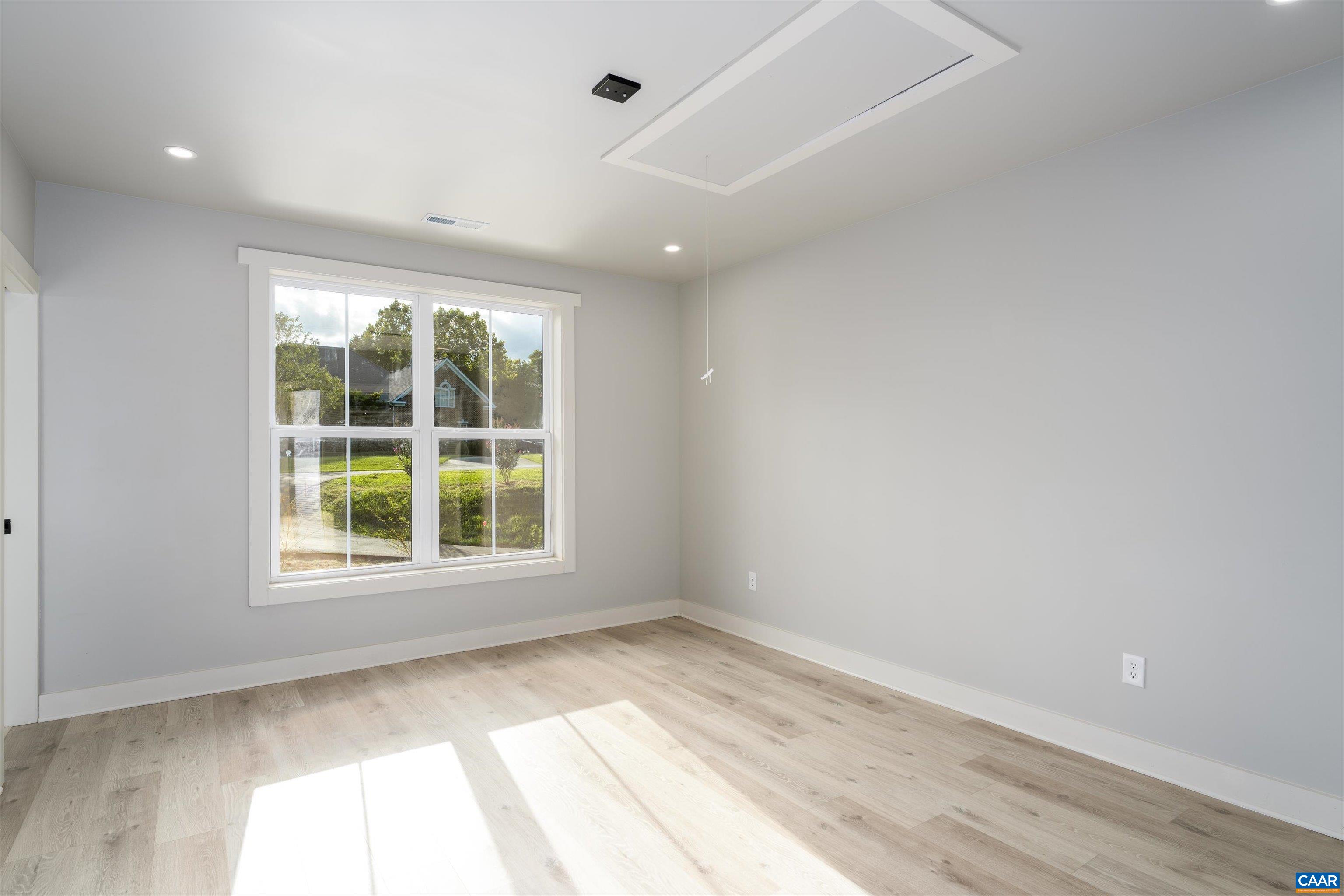 199 Ridgeview Drive Ruckersville, VA 22968 - Photo 54 of 72 an empty room with wooden floor and windows