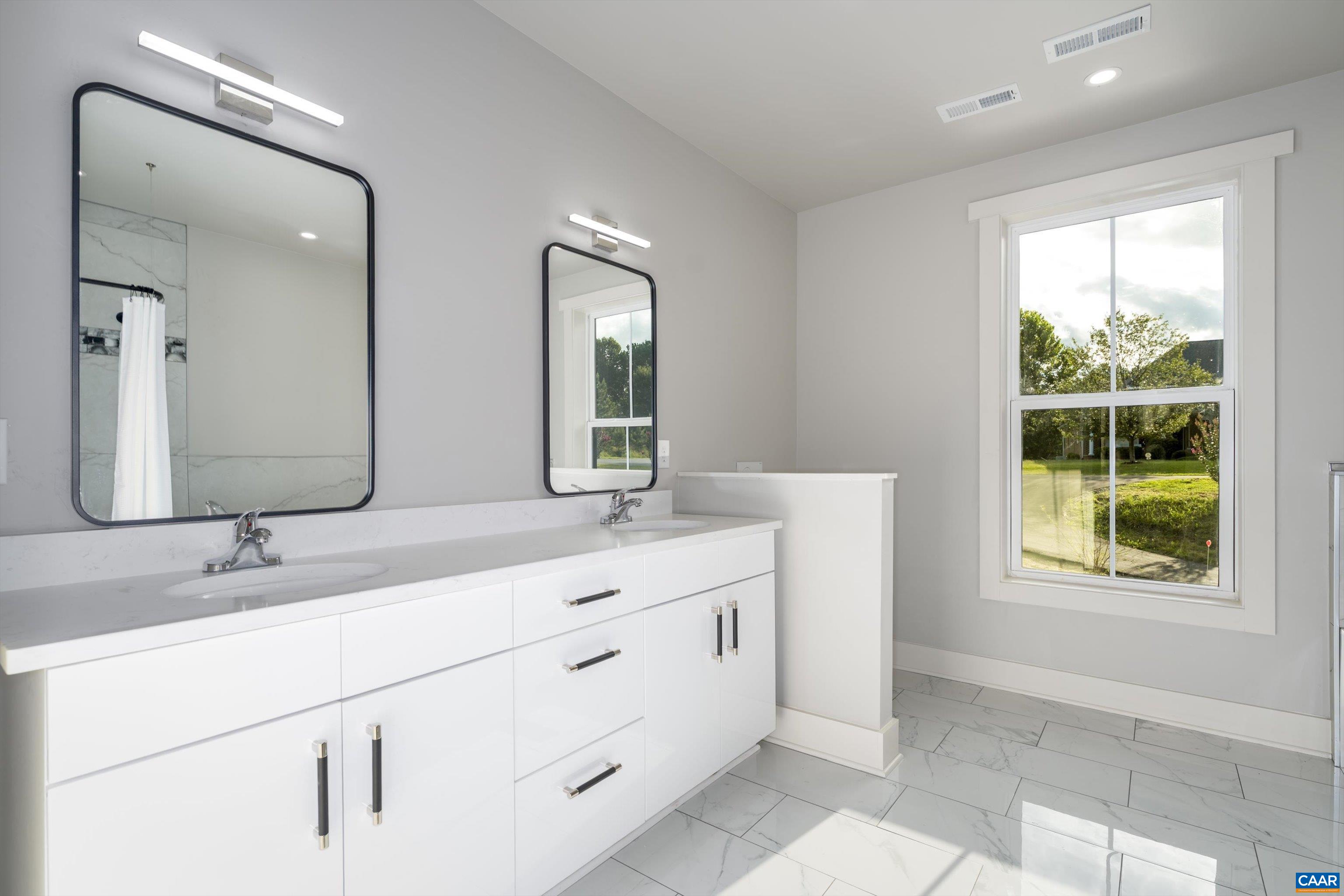 199 Ridgeview Drive Ruckersville, VA 22968 - Photo 60 of 72 a bathroom with a double vanity sink window and mirror