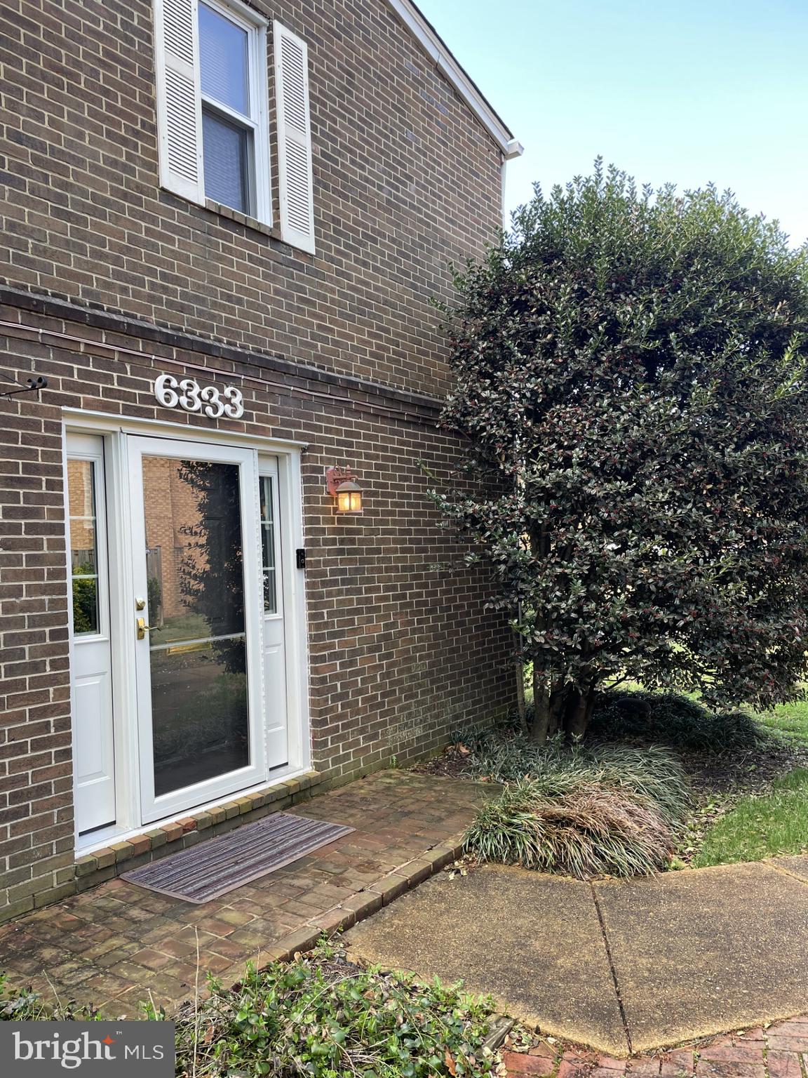 a view of a brick house with a large window