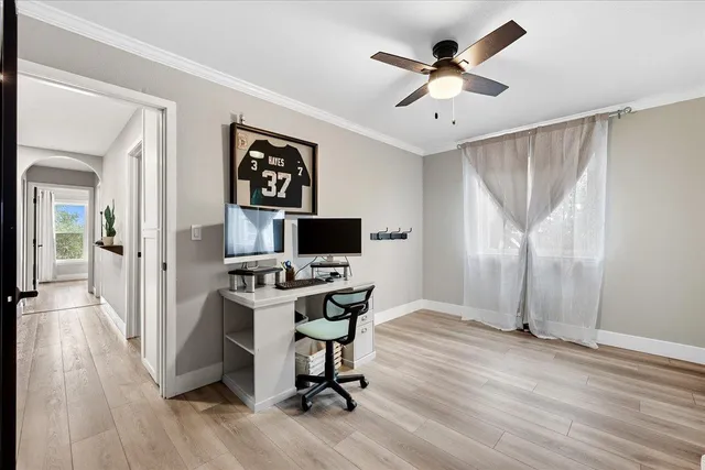 a view of a workspace with furniture and a window