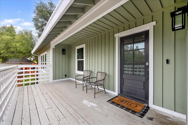 a balcony with furniture and wooden floor