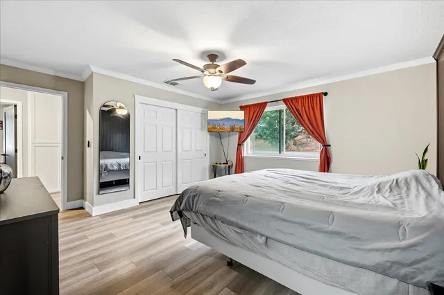 a bedroom with a bed and a chandelier