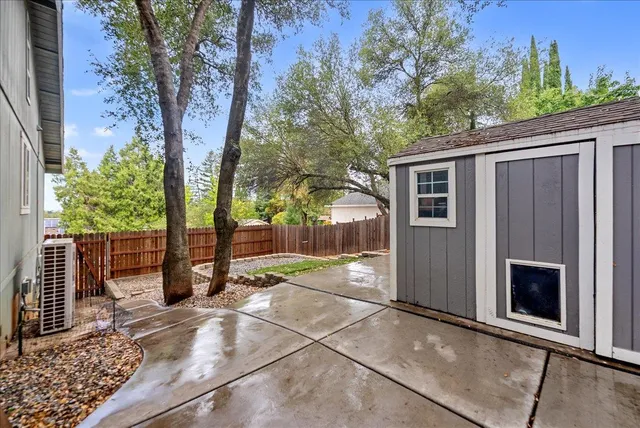 a backyard of a house with basket ball court