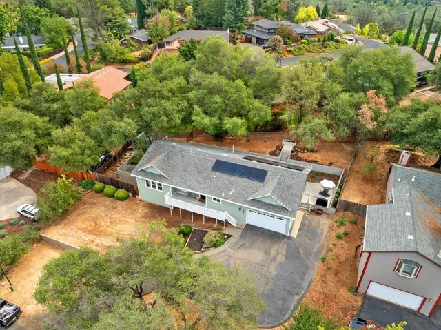 an aerial view of a house with a yard basket ball court and outdoor seating