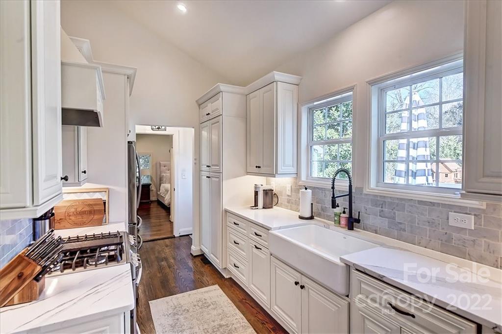3421 Park Road Charlotte, NC 28209 - Photo 11 of 40 a spacious bathroom with stainless steel appliances a sink a window and a mirror