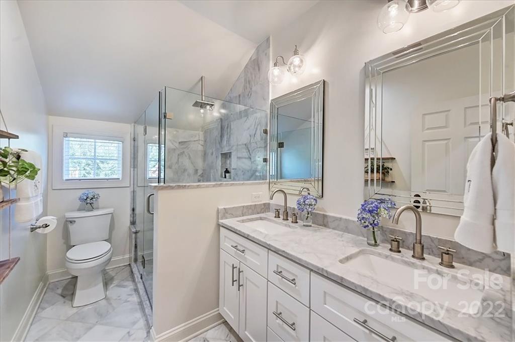 3421 Park Road Charlotte, NC 28209 - Photo 21 of 40 a bathroom with a granite countertop double vanity sink a mirror and a toilet