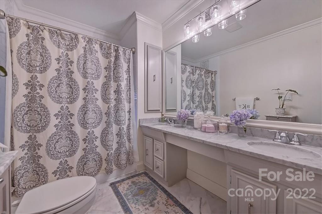 3421 Park Road Charlotte, NC 28209 - Photo 27 of 40 a bathroom with a toilet sink and mirror