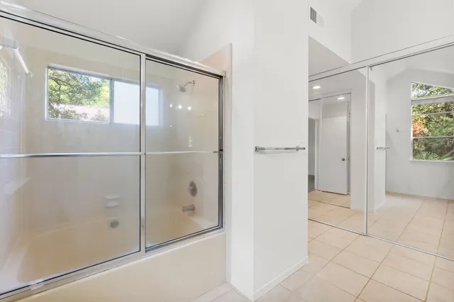 a bathroom with a glass shower door